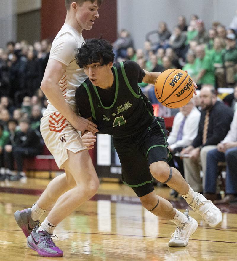 Rock Falls’ Christian Hernandez drives to the hoop against Winnebago’s Aidan Shumate Tuesday, March 4, 2025, during the 2A boys basketball Sectional final at Marengo.