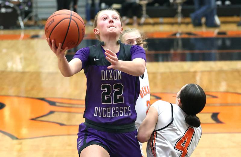 Dixon’s Katie Drew gets a layup over DeKalb’s Ella Medina during their game Monday, Jan. 23, 2023, at DeKalb High School.