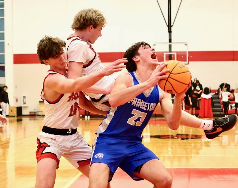 Princeton's Noah LaPorte prepares to shoot with Hall's Wyatt West following down behind him Friday night at Hall High School. The Red Devils won 62-54.