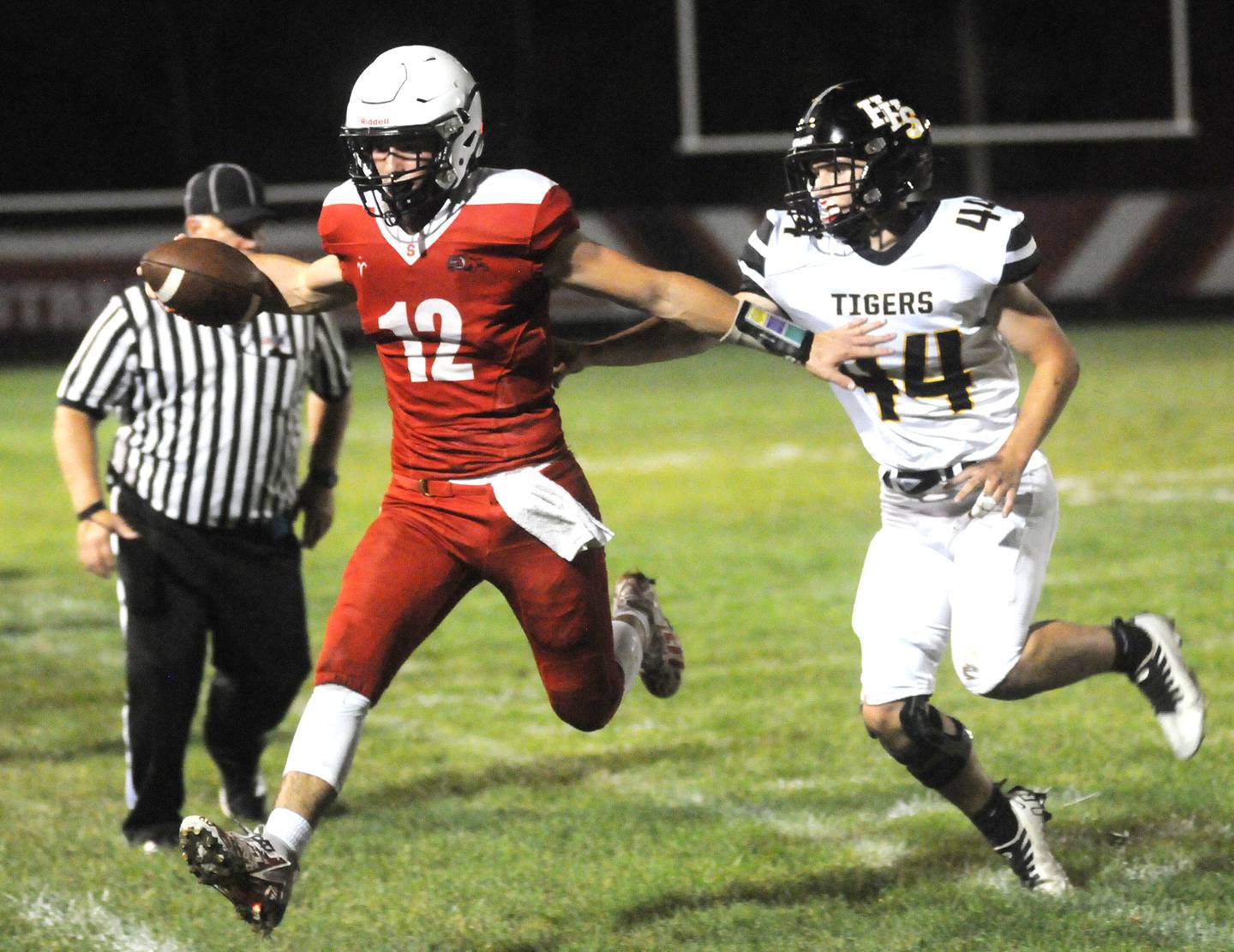 Streator quarterback Christian Benning runs out-of-bounds as Herscher's Cody Flynn reaches for him at Doug Dieken Stadium on Friday, Sept. 22, 2023.