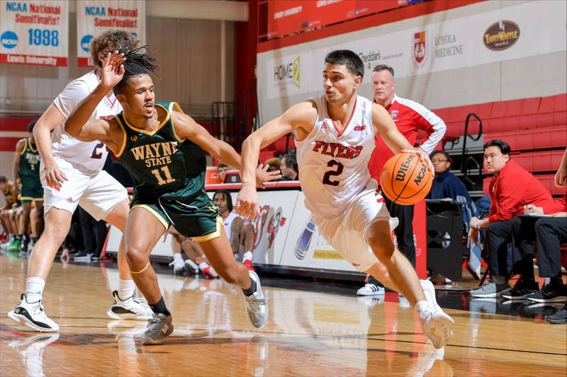 Lewis University's Beau Frericks, a Cary-Grove graduate, drives to the basket against Wayne State. Frericks leads the Flyers in scoring at 15.3 points a game.