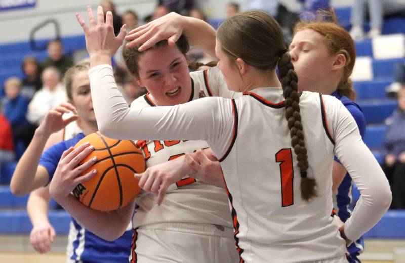 Crystal Lake Central’s Leah Spychala is swarmed after gathering a rebound against Burlington Central in IHSA Class 3A Regional Title Game girls basketball action on Thursday, Feb. 20, 2025, at  Central High School in Burlington.