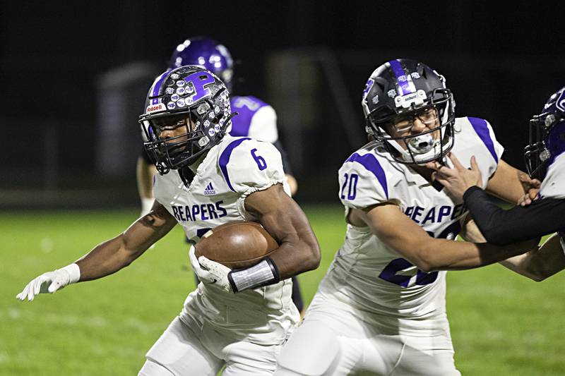 Plano’s Waleed Johnson picks up yards against Dixon Friday, Oct. 27, 2023 in Dixon.