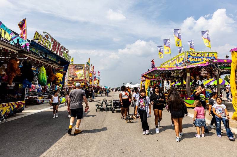 Old Canal Days attendees walk through The Midway area of the Lockport event on June, 7, 2025.