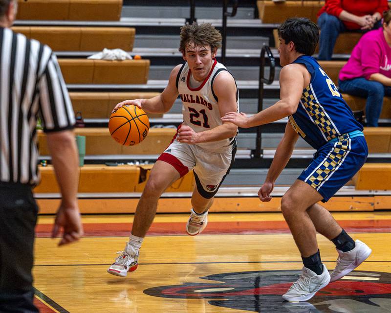 Henry-Senachwine's Carson Rowe looks to go baseline around Marquette's Matt Graham during Friday's Tri-County Conference game in Henry.