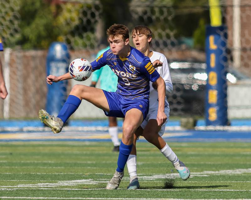Lyons Owen Suda (9) keeps the ball away from Downers Grove North's Mantas Palubinskas (6) during Class 3A Lyons Regional final soccer match.  Oct 21, 2023.