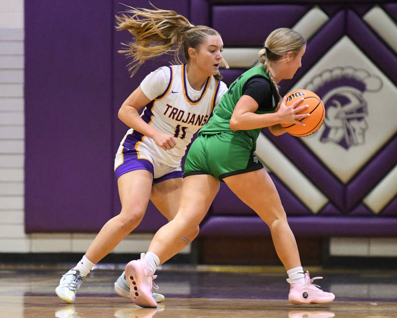 Downers Grove North's Abigail Gross, left, plays defense against York's Briley O'Brien (11) during the game on Tuesday Dec. 3, 2024, held at Dowenrs Grove North High School.