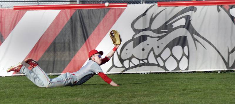 Ottawa’s Center Fielder          Cooper comes up short diving for a fly ball  against Streator Thursday at Streator.