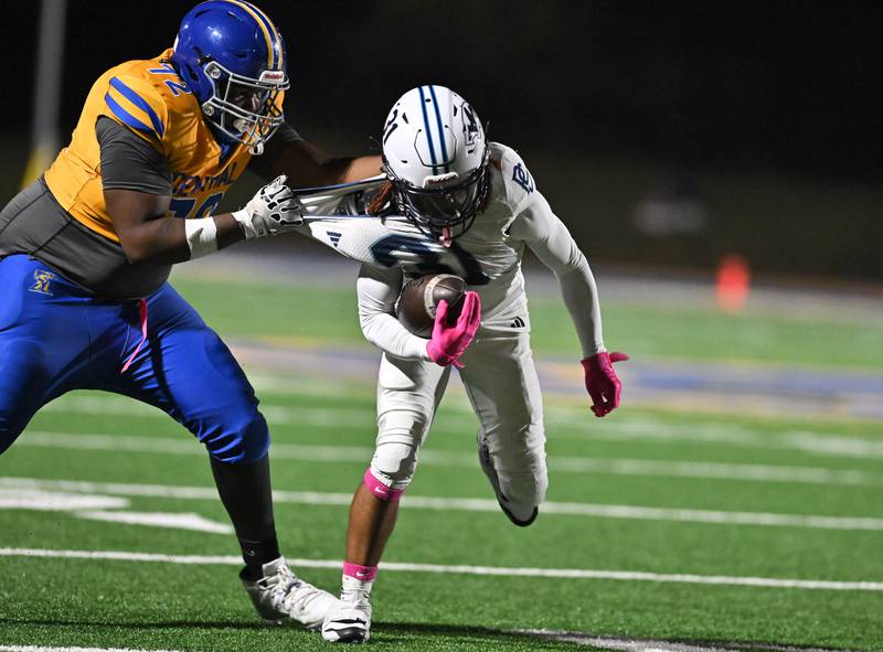Joliet Central's Marlin Johnson (72) tackling Plainfield South's Sincere Rodgers (31) during the conference game on Friday, OCT. 17, 2025, at Joliet.