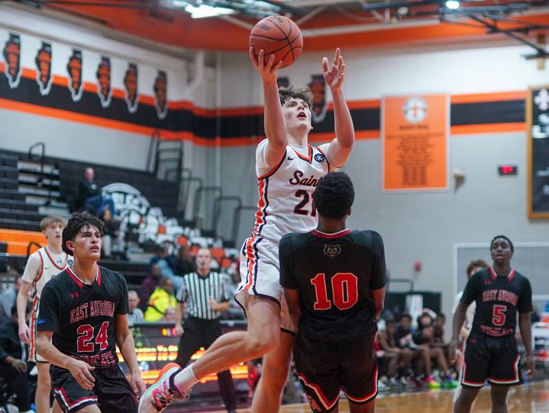 St. Charles East's Jacob Vrankovich (21) shoots the ball in the post against East Aurora's Davion Tidwell (10) during the 64th annual Ron Johnson Thanksgiving Basketball Tournament at St. Charles East High School on Monday, Nov 20, 2023.