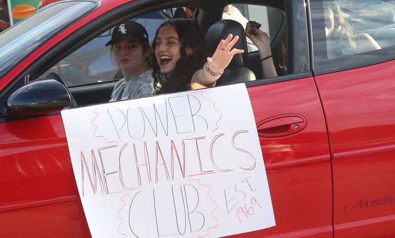 Hall High School mechanics club students ride during the Homecoming parade on Thursday, Sept. 18, 2025 downtown Spring Valley.