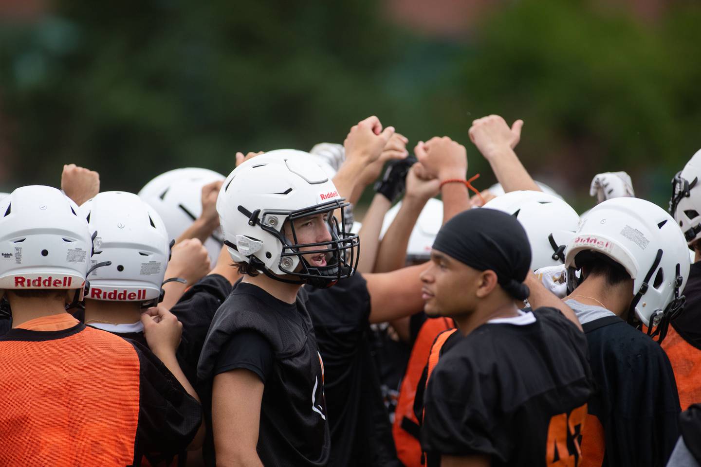 Blake Schuette chants during a huddle during practice at St. Charles East on Monday, Aug. 8, 2022.