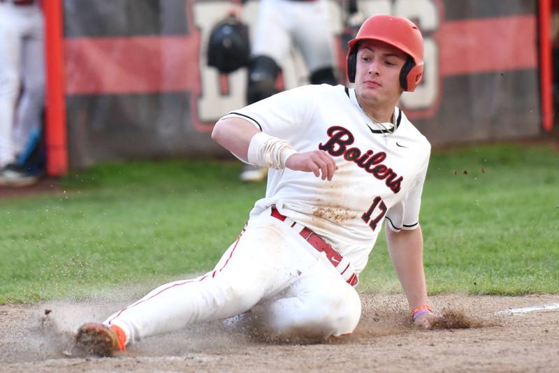 Bradley-Bourbonnais' Ellis Johnson slides in for a run during a home game against Lincoln-Way West Thursday, May 1, 2025.