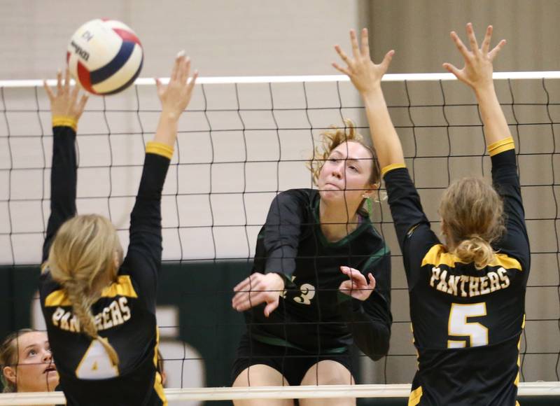 St. Bede's Ashlyn Ehm sends a kill past Putnam County's Chloe Andersen and teammate Cadence Coleman on Tuesday, Sept. 24, 2024 at St. Bede Academy.