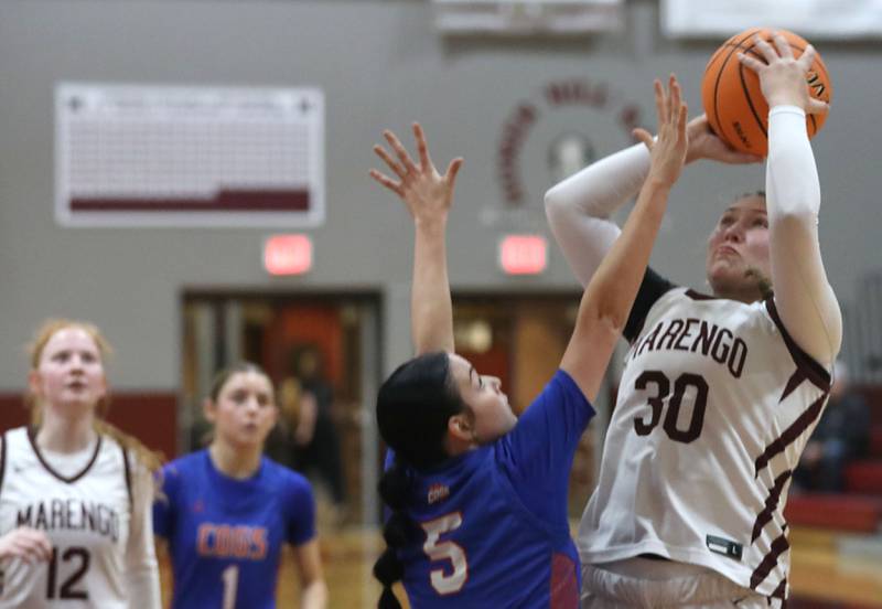 Marengo's Macy Noe (right) shoots the ball over Genoa-Kingston's Zoe Boylen during an IHSA Class 2A Marengo Regional semifinal girls basketball game on Monday, Feb. 16, 2026, at Marengo High School.