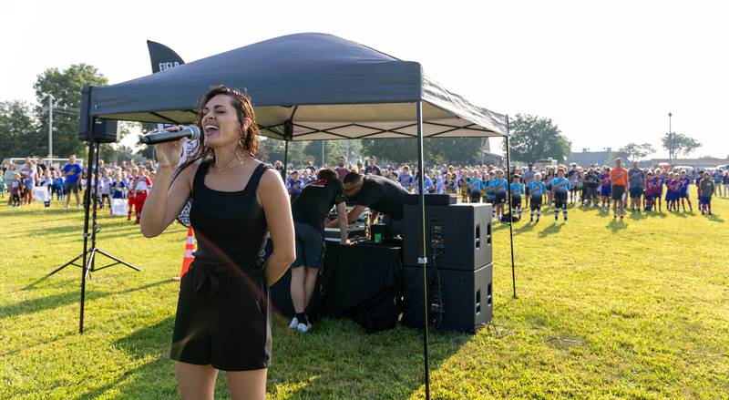 Players gather at the East McKinley Fields on Saturday, Aug. 19, 2023, as the "Star Spangled Banner" is performed.