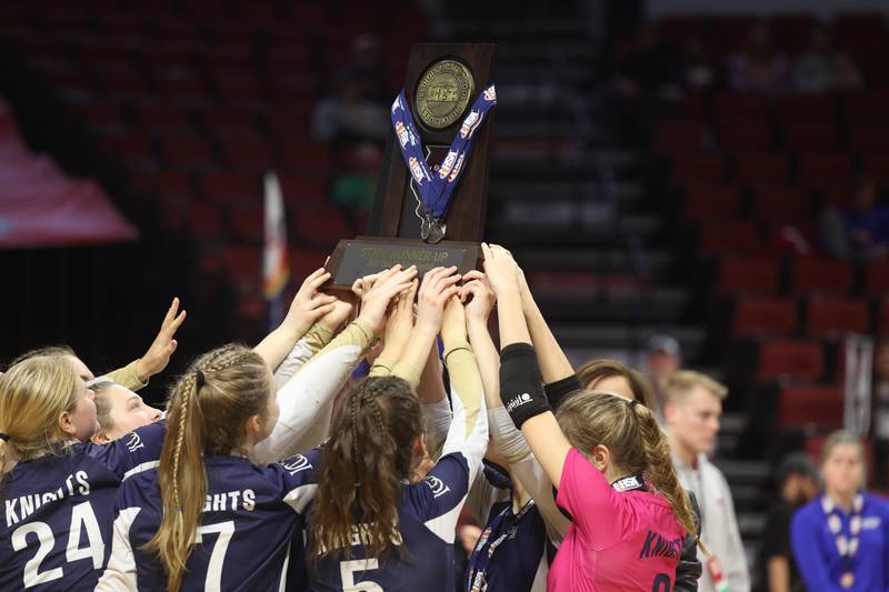 IC Catholic holds up the 2nd place trophy after a loss against Genoa-Kingston in the Class 2A championship match on Saturday in Normal.
