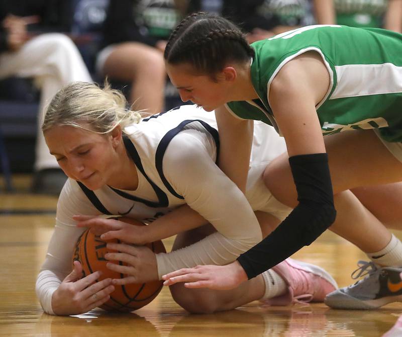 Cary-Grove's Malaina Kurth battles with Crystal Lake South's Mallory Glover for a loose ball during a Fox Valley Conference girls basketball game on Tuesday, Dec. 2, 2025, at Cary-Grove High School in Cary.