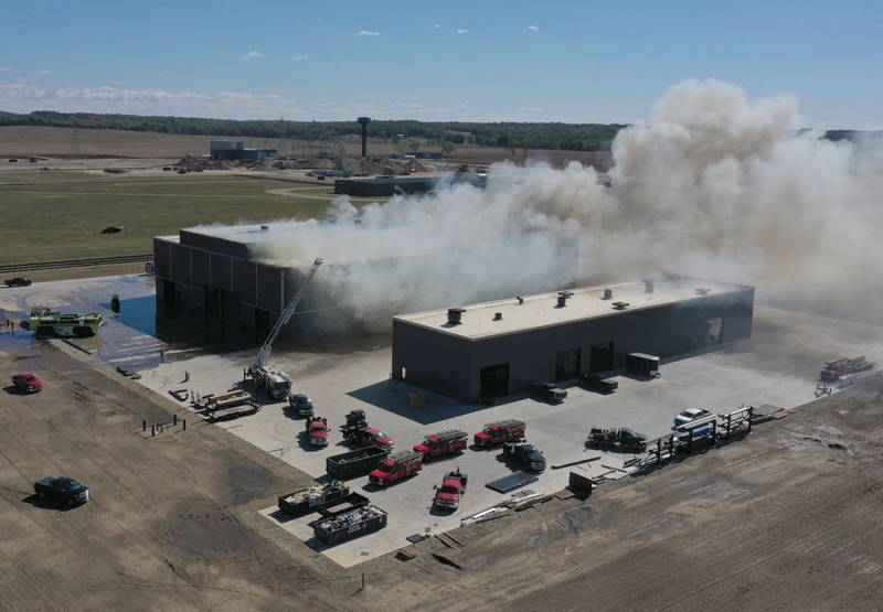 Smoke billows from Marquis Energy as firefighters work to control a structure fire on Wednesday, Oct. 8, 2025 in Hennepin. The fire was upgraded to a 5th alarm dispatching the (MABAS) Mutual Aid Box Alarm System. The fire broke out around 11a.m.