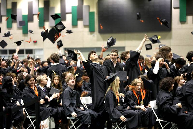 Wheaton Warrenville South graduates throw their caps in the air during the school’s commencement ceremony on Saturday, May 24, 2025 at the College of DuPage in Glen Ellyn.