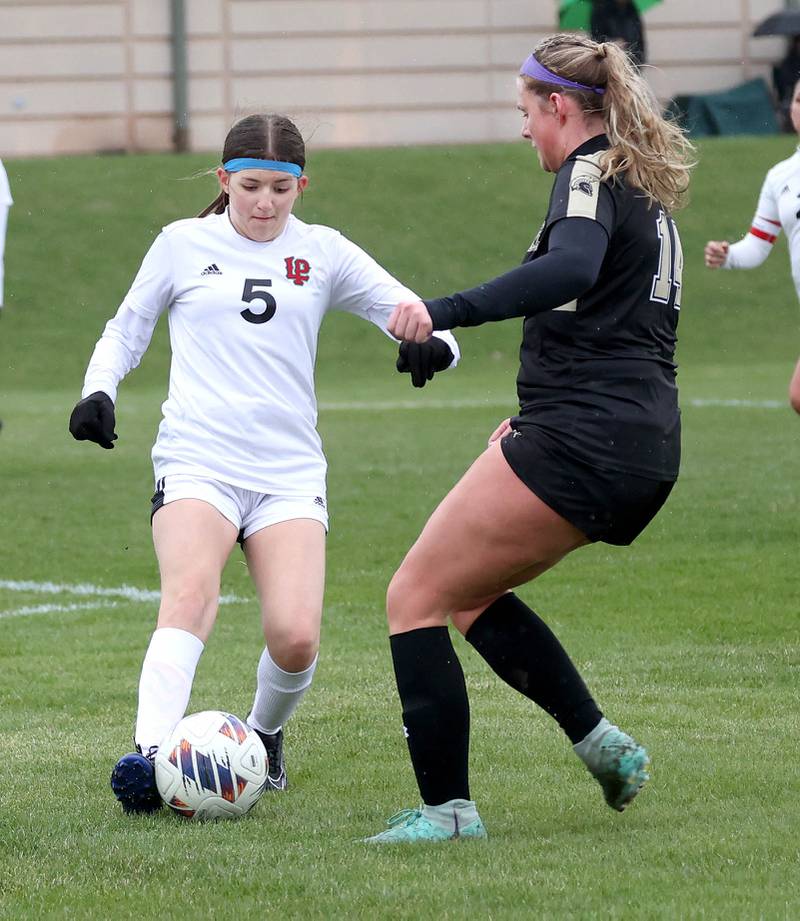 La Salle-Peru's Lilyana Hernandez tries to keep the ball away from Sycamore's Peyton Wright during their game Wednesday, April 9, 2025, at Sycamore High School.