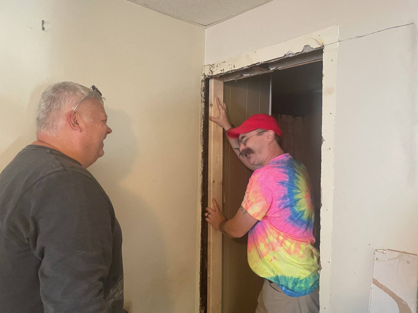 DeWayne Cronkright (left) and Ottawa Mayor Robert Hasty share a laugh while working on a Labor of Love project in the 600 block of East Superior Street in Ottawa. The Labor of Love will help 26 homeowners with projects on Oct. 5 this year.