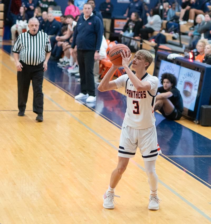 Oswego’s Nolan Petry (3) spots up for a three point shot against Oswego East during a basketball game at Oswego High School on Tuesday, Dec 12, 2023.