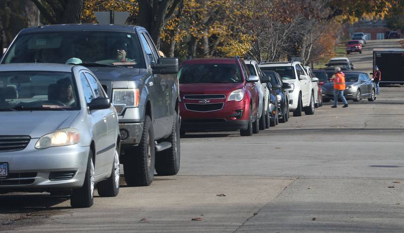 A long line of vehicles stretches over three-blocks long for the annual Thanksgiving distribution on Wednesday, Nov. 20, 2024 at the Hall Township Food Pantry in Spring Valley.