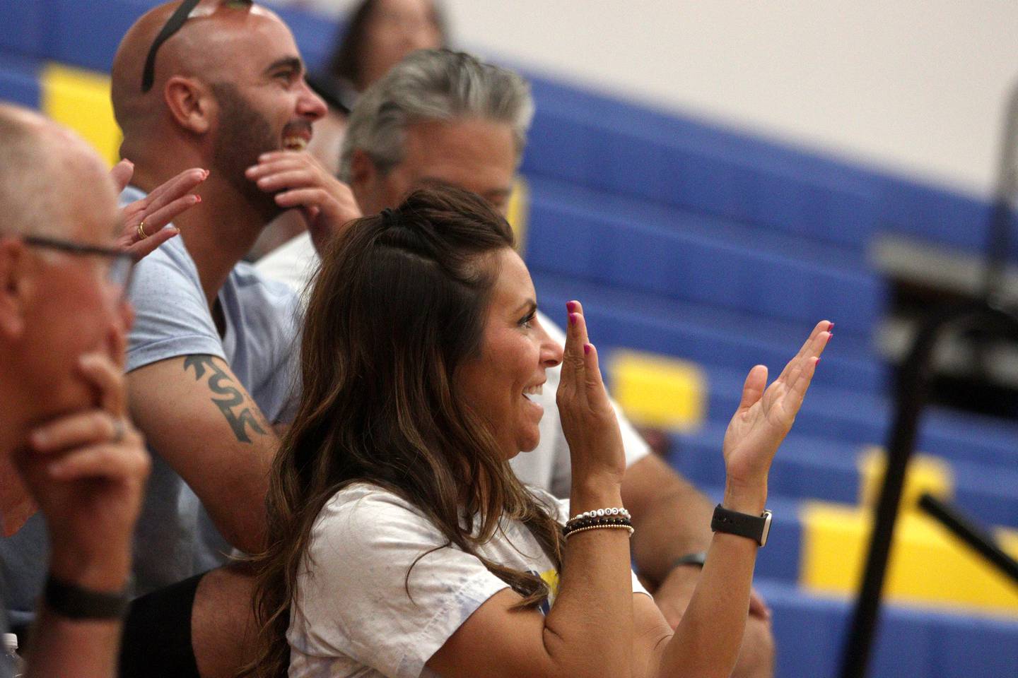 Matt, top, and Amber Werderitch enjoy the action during an alumni basketball game at Johnsburg High School Saturday evening to benefit their family. Their son Jackson Werderitch, 10, was struck by a car and injured.