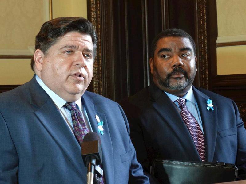 With then acting DCFS Director Marc Smith looking on, Gov. JB Pritzker (left) talks in May 2019 about addressing the recommendations in a study for reforming the state’s Department of Children and Family Services.