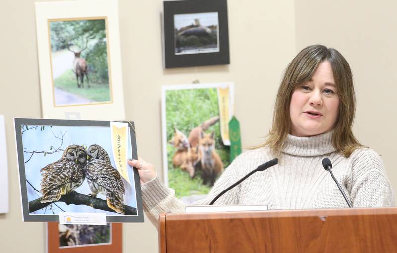 Heather Farrell holds her 4th place in show photo of owls during the Starved Rock Photography Show awards on Saturday, Jan. 4, 2024 at the Starved Rock Visitors Center.
