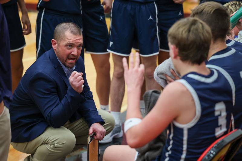 Coach Jeremy Hahn of Fieldcrest talks to players during time out on Saturday, December 14, 2024 at Hall High School in Spring Valley.