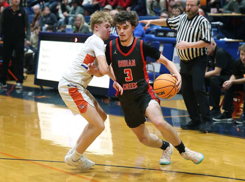 Indian Creek's Logan Schrader drives by Genoa-Kingston's Trevor Rhoads during their game Friday, Jan. 2, 2026, at Genoa Kingston High School.