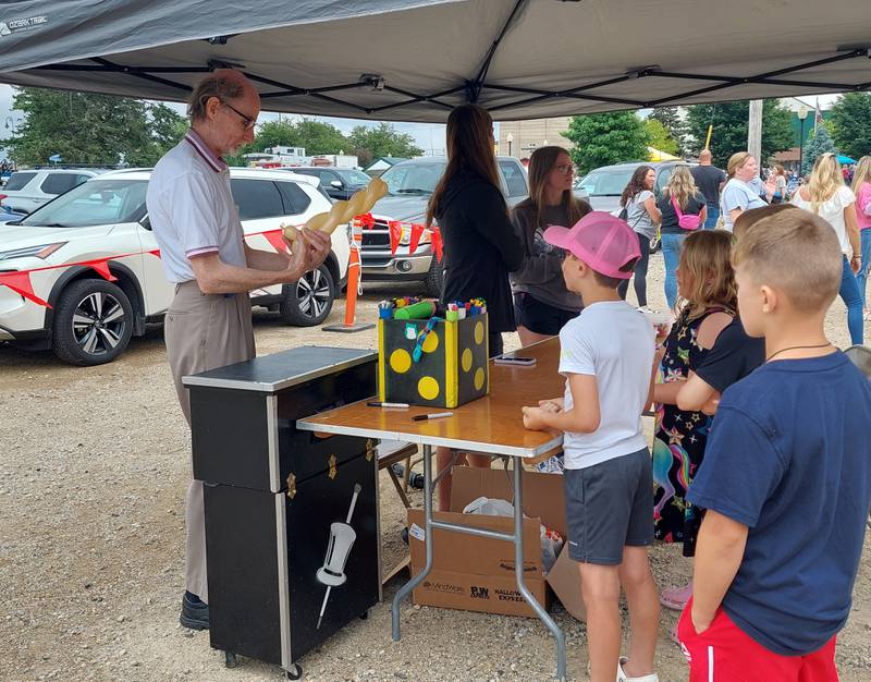 Mr. Cinnamon makes a balloon creation Saturday, June 1, 2024, for children during the ShrimpFest Brew and Hullaballoo at Rotary Park in Princeton.