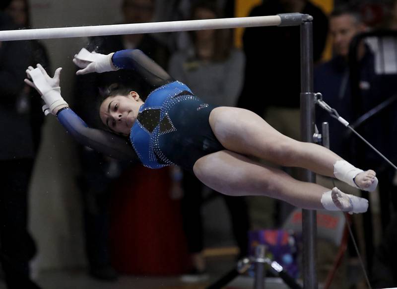 Downers Grove South’s Genevieve Herion competes in the preliminary round of the uneven parallel bars Friday, Feb. 17, 2023, during the IHSA Girls State Final Gymnastics Meet at Palatine High School.