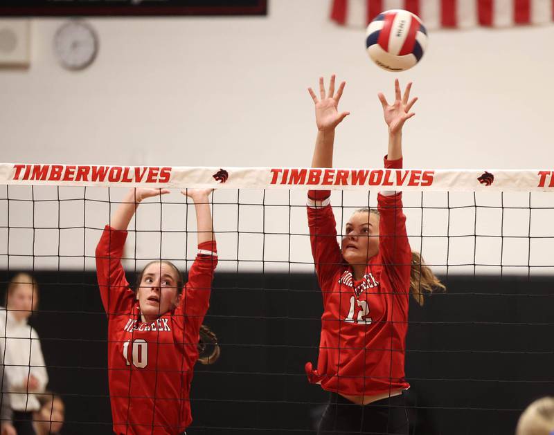 Indian Creek's Ally Keilman (left) and Taylor Edwards try to block a Hinckley-Big Rock spike during their match Tuesday, Sept. 9, 2025, at Indian Creek High School in Shabbona.
