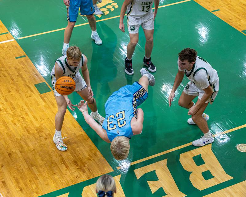 Luke McCullough (23) of Marquette throws ball behind back in attempt to save it from falling out of bounds as St. Bede's defense watches on Friday, January 16, 2026 at St. Bede Academy in Peru.