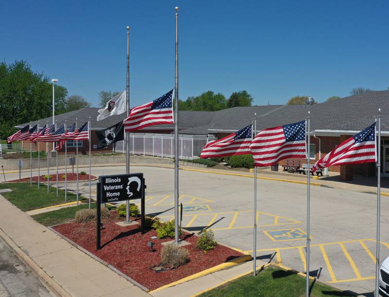 Flags blow in the wind outside the Illinois Veterans Home in La Salle on Friday April 30, 2021.