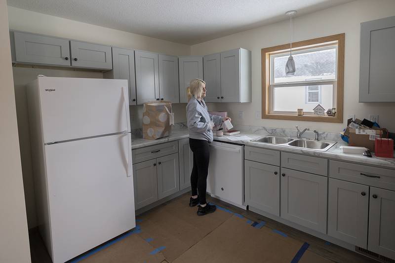 Steeb works to set up her kitchen Sunday, Dec. 22, 2024, after the Habitat for Humanity home dedication.