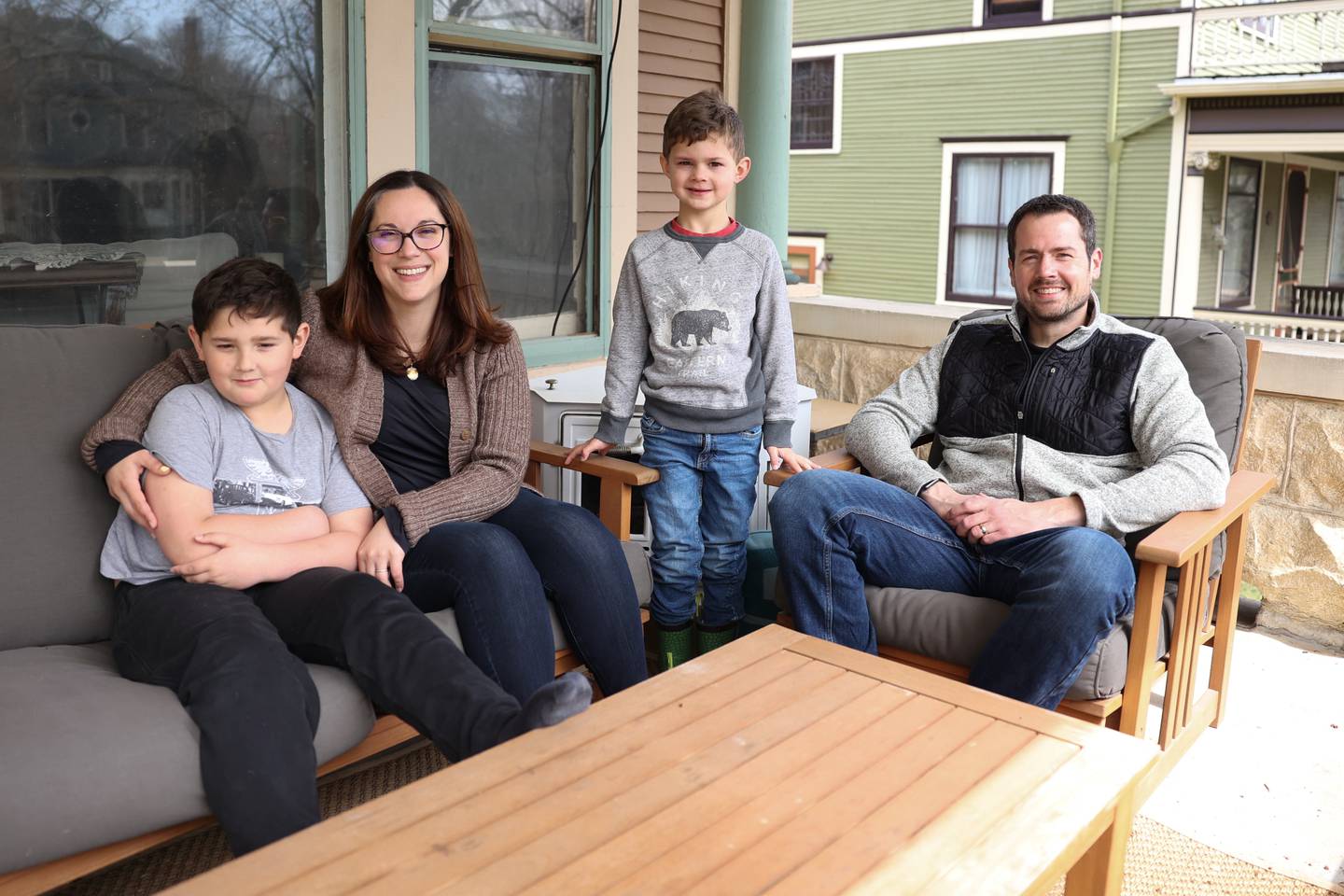 The Brzycki family, Max, left, Emily, Owen and Jeremy sit on their front porch in Joliet. Friday, April 15, 2022, in Joliet.