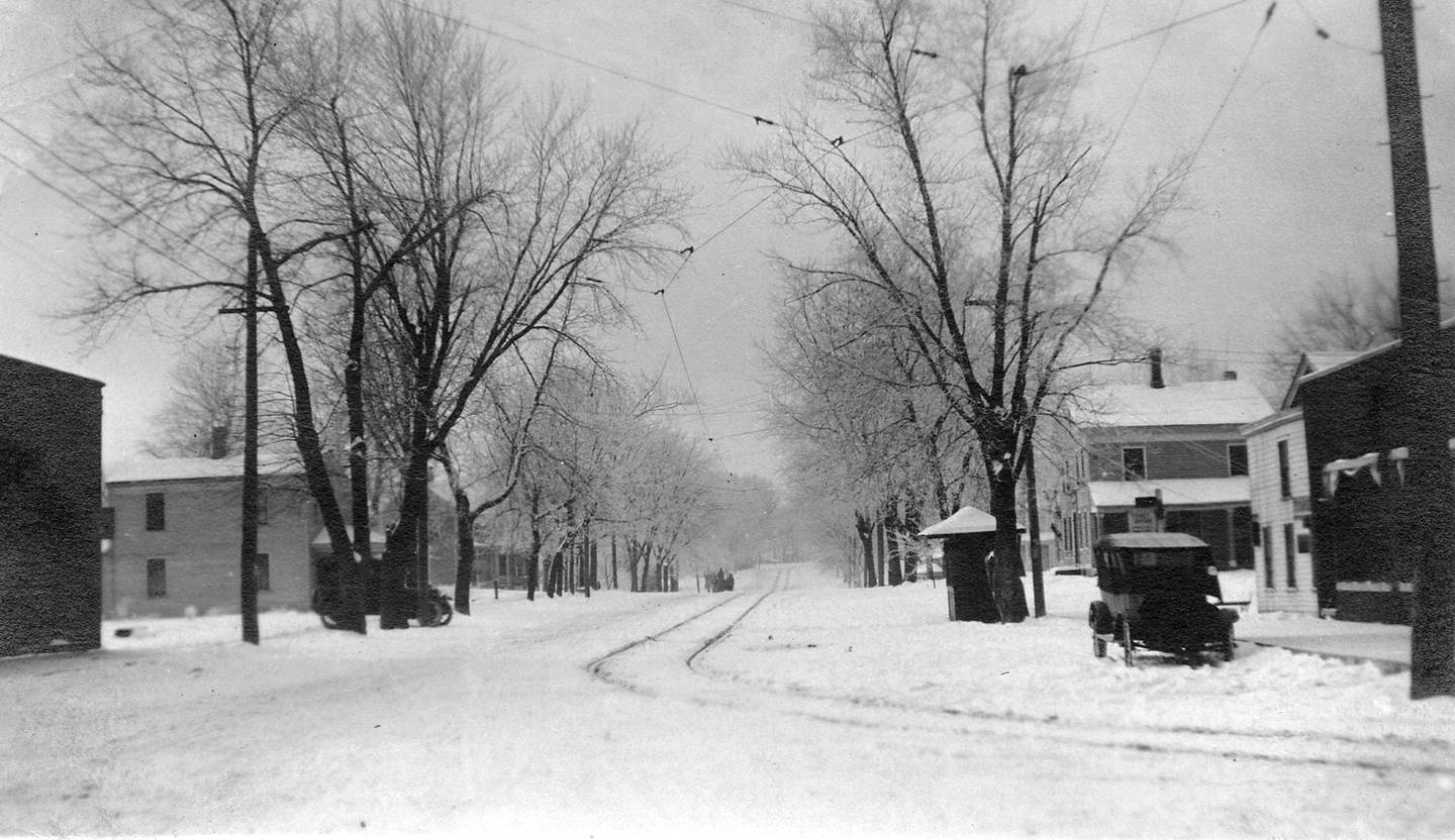 Looking south on Oswego's Main Street from Washington Street (Route 34) following a snowstorm in about 1910. Note the trolley tracks in the center of the street. (Photo provided by the Little White School Museum)