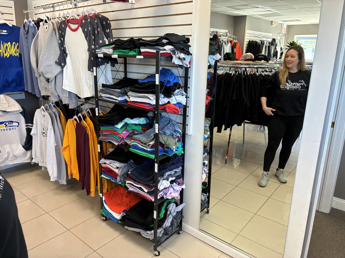 Tiff Freund at Freundly Designs in McHenry on Wednesday, Feb. 11, 2026. By selling "Riverside Strong" apparel for two McHenry stores damaged in a fire, Freund has raised more than $13,000 for the two businesses.