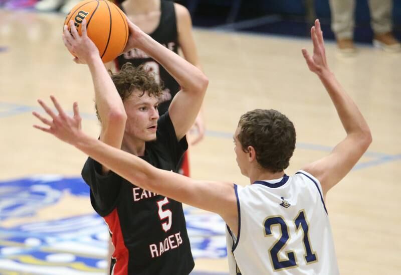 Earlville's Gavin Guelde looks to pass around Marquette's Lucas Craig on Friday, Jan. 3, 2025 in Bader Gym at Marquette High School.