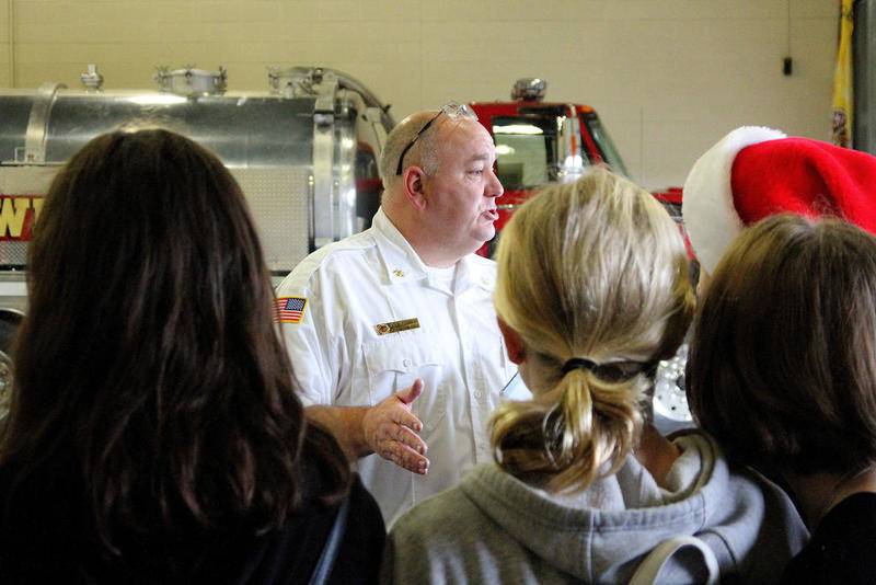Assistant Chief John Cornish directed junior high students on where to place the donated toys, as part of the annual Toys for Tots drive at Oswego Fire Protection District Station 1, Friday, Dec. 13.