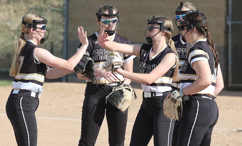Sycamore's Alyssa Wilkerson (middle) is congratulated by her infield after striking out a LaSalle-Peru batter during their game Tuesday, April 11, 2023, at Sycamore High School.