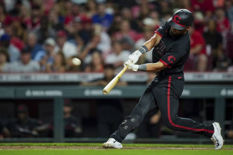 Cincinnati Reds outfielder Nick Martini hits a solo home run during the ninth inning against the Chicago Cubs in Cincinnati, Friday, Sept. 1, 2023.