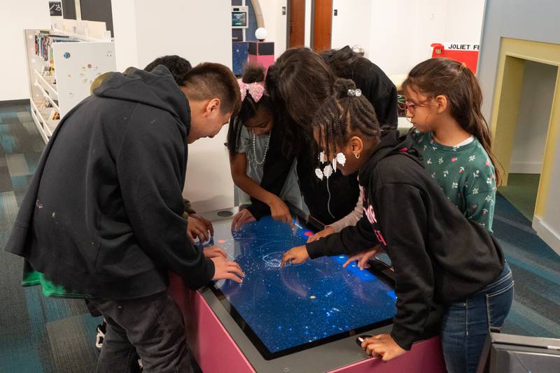 The Joliet Public Library at 150 N. Ottawa St. in Joliet is hosting an all-ages, interactive Exoplanet exhibit from NASA through Feb. 28. Pictured are Carlos Ramirez, Leah Needon, Rheah Needon, Miranda Espina and Bella Ramirez .
