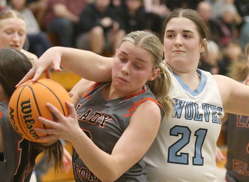 Cissna Park's Lauryn Hamrick knocks the ball out of the hands of Flanagan-Cornell/Woodland's Kora Edens during the Class 1A Sectional semifinal game on Tuesday, Feb. 25, 2025 at Midland HIgh School.