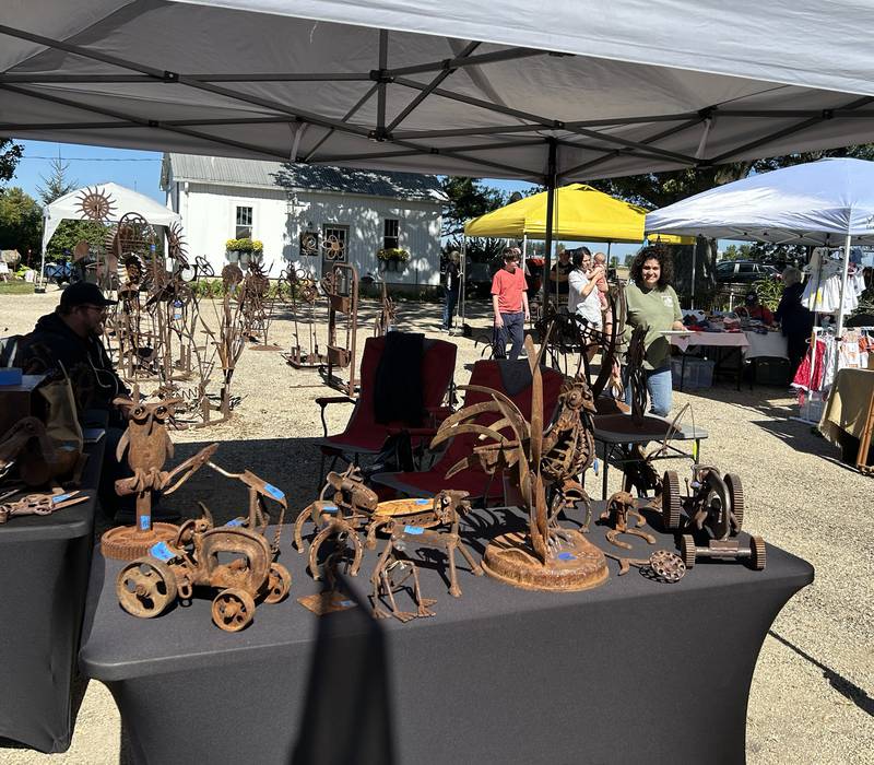 Lynette Hough walks by some of the items for sale at Hough's Maple Lane Farm during the Back Roads Market event on Saturday, Sept. 28, 2024 north of Mt. Morris. The event included several stops near Mt. Morris.