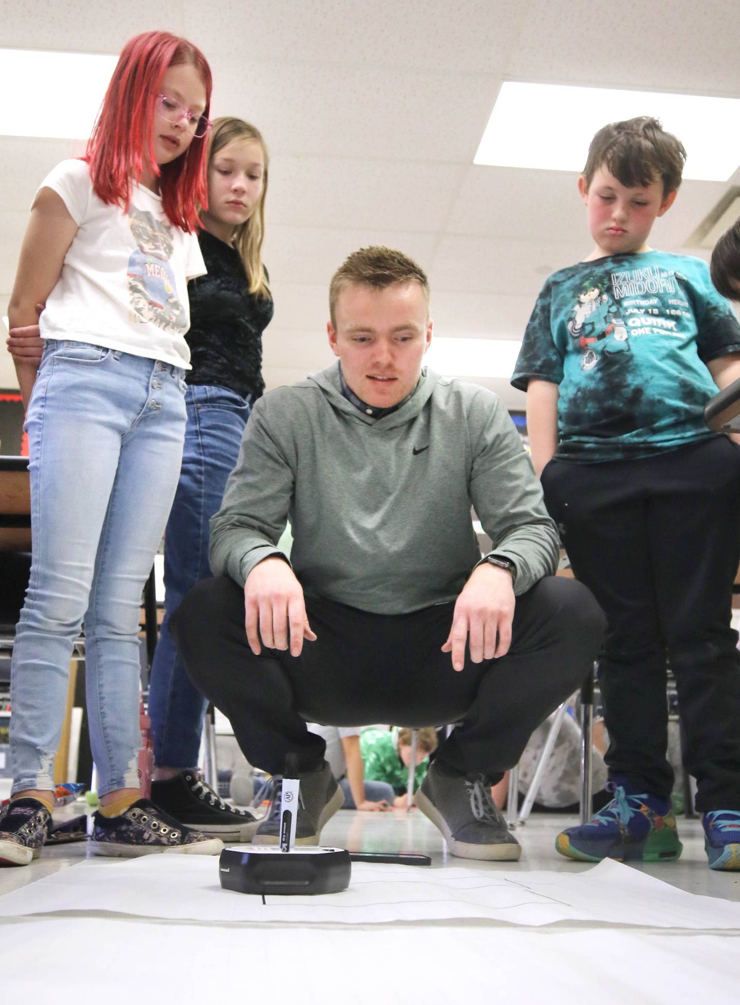 Jacob Winters, fourth grade teacher at South Prairie Elementary School, works with students during a robotics lesson Wednesday, April 6, 2023, at the school in Sycamore.